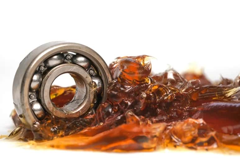 An image shows a ball bearing with grease lubrication.