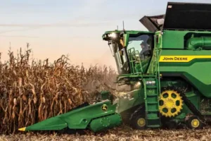 A John Deere tractor working in a field on a Brazilian farm.