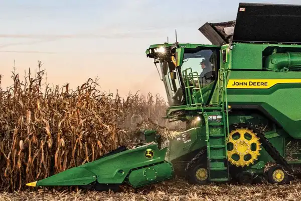 A John Deere tractor working in a field on a Brazilian farm.