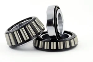 Close-up view of a tapered roller bearing showing its conical rollers, inner ring, outer ring, and cage.