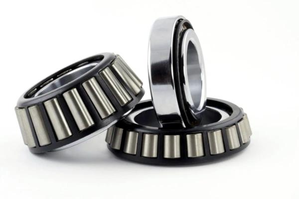 Close-up view of a tapered roller bearing showing its conical rollers, inner ring, outer ring, and cage.