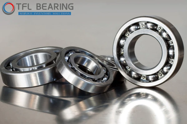 A promotional image for TFL company products, showing various types of bearings