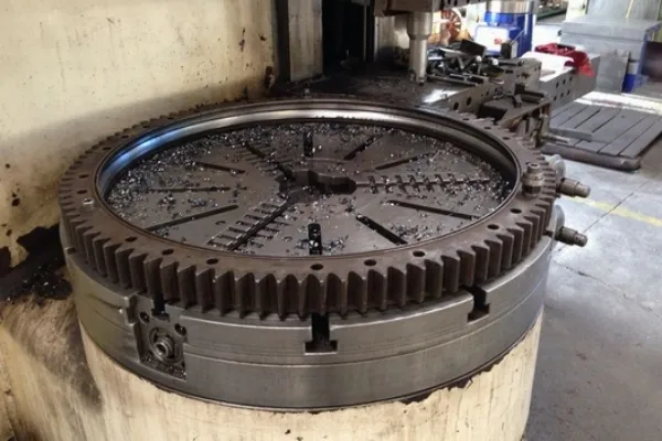 An image of an industrial slewing bearing showing discoloration and metal shavings.