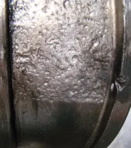 image shows the bearing fatigue spalling on surface
