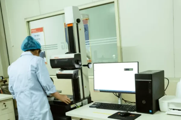 A technician is checking whether the parameters of the custom-made bearings are within the acceptable range.