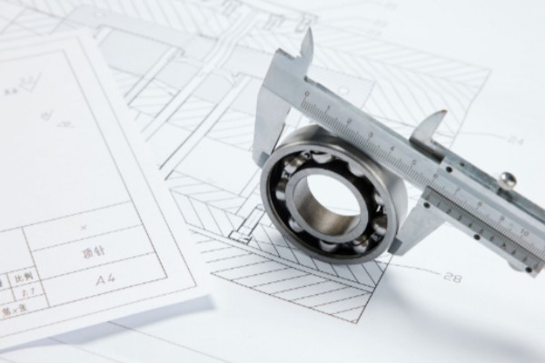 SDTFL engineers discussing custom bearing solutions for non-standard applications
