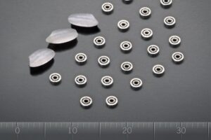 A collection of high-precision miniature ball bearings displayed on a clean surface, highlighting various sizes.