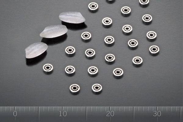 A collection of high-precision miniature ball bearings displayed on a clean surface, highlighting various sizes.