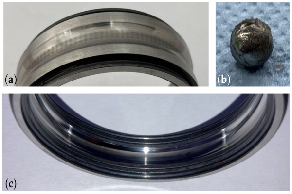 Macro shot showing discoloration and pitting on metal surfaces, indicating visual bearing replacement signs.