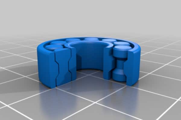 A close-up view of a 3D printed ball bearing showing the layered structure and polymer materials.
