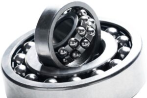 Industrial self-aligning ball bearing compensating for shaft deflection and mounting inaccuracies