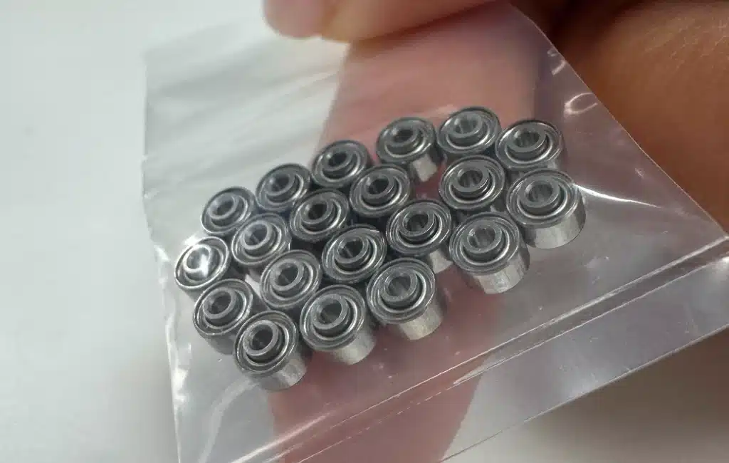 Close-up of EZO SRW0ZZ miniature shielded bearings in a plastic bag